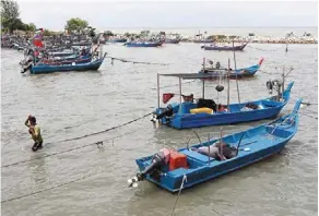  ?? ?? Threatened: The livelihood­s of malaysia’s artisanal and coastal fishermen – like these at sungai batu in Teluk Kumbar, Penang – are at risk from the climate crisis. — Filepic/the star