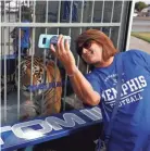  ?? JOE RONDONE, JOE RONDONE/THE COMMERCIAL APPEAL ?? Memphis fan Susan Meadors takes a selfie with Tom III before the Tigers play their game against Navy at the Liberty Bowl Memorial Stadium on Thursday, September 26, 2019.