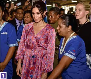  ??  ?? Crowded: Meghan begins her visit to a sweltering market yesterday 1