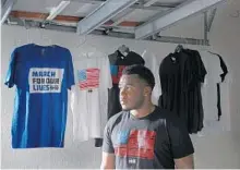  ?? AMY BETH BENNETT/SUN SENTINEL ?? March For Our Lives creative director Jammal lemy is shown in his garage studio where he first started designing t-shirts at his Coral Springs home.