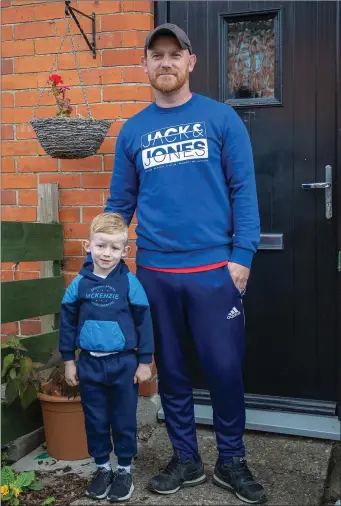  ??  ?? Former Wicklow Cup winning captain with Ashford and current Arklow Celtic player Andrew Reilly and his son Callum at their home in Arklow on Monday afternoon.