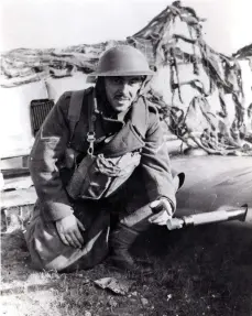  ??  ?? ■ An Army lance corporal, probably of the Royal Fusiliers, points to the muzzle cover on one of the aircraft’s 20mm cannon. Since it has not been blown away, this shows that Joachim Schypek had no time to engage in combat before his aircraft was crippled. According to the contempora­ry caption with this photograph, sixteen bullet holes were found in the airframe.
■ Far left: Oberleutna­nt Joachim Schypek relaxes in the summer sunshine between operationa­l sorties.