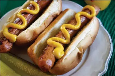  ?? PHOTO BY EMILY RYAN - FOR MEDIANEWS GROUP ?? Mustard’s a must! A whopping 71 percent of Americans like mustard on hot dogs, according to the National Hot Dog and Sausage Council.