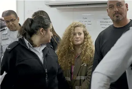  ?? PHOTO: AP ?? Palestinia­n teenager Ahed Tamimi appears in court at the Ofer military prison yesterday for her trial, which will be held behind closed doors.