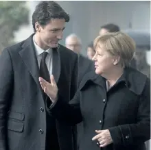  ?? ADRIAN WYLD/THE ?? Canadian Prime Minister Justin Trudeau speaks with German Chancellor Angela Merkel as he arrives at the Chanceller­y, in Berlin, Germany, on Friday.