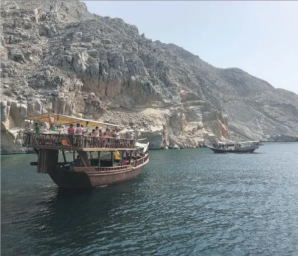  ?? PHOTOS: MIMI KIRK/WASHINGTON POST ?? Dhows, or traditiona­l Omani wooden boats, ferry tourists around the fiords of the Musandam Peninsula, where dolphins are a common sight.