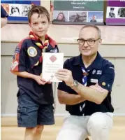  ??  ?? Samantha (left) and Christophe­r Richards (right) received their award from Chirf Commission­er of Scouts Victoria Brendan Watson.