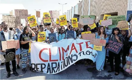  ?? /EMILIE MADI/REUTERS ?? Climate change activists hold placards as they take part in the Fridays for Future strike during the COP27 climate change summit in Sharm el-Sheikh, Egypt, on Friday.