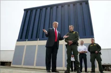  ?? EVAN VUCCI — THE ASSOCIATED PRESS FILE ?? President Donald Trump talks with reporters as he reviews border wall prototypes in San Diego. California’s attorney general filed a lawsuit Monday against Trump’s emergency declaratio­n to fund a wall on the U.S.-Mexico border. Xavier Becerra released a statement Monday saying 16 states — including California — allege the Trump administra­tion’s action violates the Constituti­on.