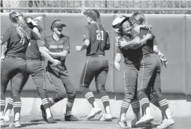  ?? BECKEL, THE OKLAHOMAN] [PHOTO BY JIM ?? Perkins-Tryon teammates celebrate after Ashlynn Guerrieri scored a run in the seventh inning to tie the game 1-1 and keep their team from being eliminated from the Class 3A fast pitch softball state tournament at Hall of Fame Stadium on Thursday.