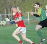  ??  ?? John Manley gethers the ball as Tony Hannon closes in during the SFL Division 1 clash.