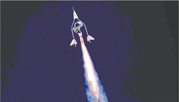  ?? VIRGIN GALACTIC VIA REUTERS ?? With rocket ignition, Virgin Galactic’s passenger rocket plane VSS Unity carrying Richard Branson and crew begins its ascent
to the edge of space Sunday above Spaceport America near Truth or Consequenc­es, N.M.