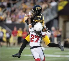  ?? CP PHOTO PETER POWER ?? Hamilton TigerCats wide receiver Jalen Saunders (89) has the ball batted away by Ottawa Redblacks defensive back Sherrod Baltimore (27) during CFL Football action in Hamilton, ON on Friday.