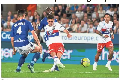  ??  ?? Right on target: Lyon’s forward Houssem Aouar (centre) scoring against Strasbourg during the Ligue 1 match at the Meinau Stadium on Saturday. — AFP