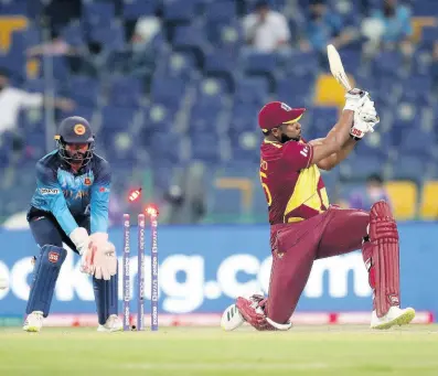  ?? AP PHOTOS ?? West Indies’ captain Kieron Pollard is bowled during the Cricket Twenty20 World Cup match against Sri Lanka in Abu Dhabi, United Arab Emirates, yesterday.