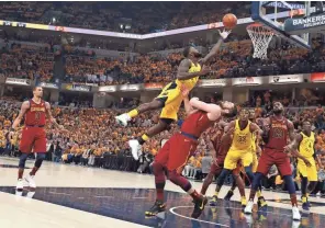  ??  ?? Pacers guard Lance Stephenson takes a shot against Cavaliers forward Kevin Love in Friday’s 92-90 Indiana victory.