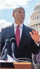  ?? ANDREW HARNIK/AP ?? Sen. Cory Booker, D-N.J., center, is one of the co-sponsors of the ‘College Athletes Bill of Rights’ bill.