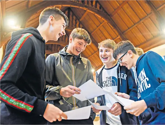  ??  ?? Boys at Bolton School, Greater Manchester, celebrate receiving their GCSE results today