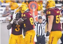  ?? RALPH FRESO/ ASSOCIATED PRESS ?? Arizona State running back Eno Benjamin (3) receives congratula­tions from Frank Darby (84) after scoring a TD in the Sun Devils’ rout of UTSA last week.