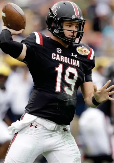  ?? (Photo by Chris O'Meara, AP) ?? South Carolina quarterbac­k Jake Bentley throws a pass against Michigan during the first half of the Outback Bowl on Monday.