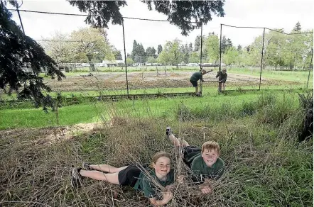  ?? JOHN BISSET/STUFF ?? Winchester Rural School pupils Lucy Johnson, 8, and Josh Leonard, 9, would like to enhance the area next to the school to benefit the community.