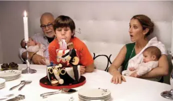  ??  ?? Dion’s son René-Charles celebrates his 10th birthday with father René, twin brothers Nelson and Eddy, and mom in a scene from Celine: 3 Boys and a Show, which aired on OWN in Canada on Oct. 2, 2011.