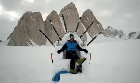  ??  ?? King of the mountain: Mark on a throne of snow and ice in front of Antarctica’s Organ Pipe Mountains.