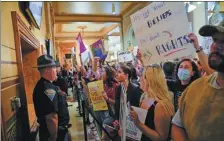  ?? CHENEY ORR / REUTERS ?? Activists protest outside the Senate chambers at the Indiana statehouse in Indianapol­is during a special session debating abortion on Monday.