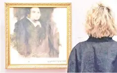  ??  ?? A woman looks at a work of art created by an algorithm by French collective named OBVIOUS which produces art using artificial intelligen­ce, titled ‘Portrait of Edmond de Belamy’, at Christie’s in New York in this file photo. — AFP photo