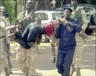  ?? PICTURE: EPA ?? SAVED: An injured hostage is carried by security forces from the Radisson Blu hotel during the attack yesterday.