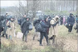  ?? LEONID SHCHEGLOV — BELTA VIA AP ?? Migrants amass Monday near Grodno, Belarus, at the border with Poland. The autocratic regime of Belarus has encouraged migrants to illegally enter the European Union.