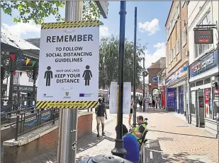  ??  ?? Ashford appears at number seven on a list showing ‘areas of concern’ for further coronaviru­s outbreaks, right, social distancing signs in the town centre