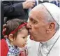  ?? Paulo Cunha / Associated Press ?? Pope Francis kisses a child as he arrives Friday in Leiria, Portugal.