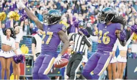  ?? KENNETH K. LAM/BALTIMORE SUN ?? The Ravens’ Cyrus Jones celebrates after returning a punt 70 yards for a touchdown in the second quarter. The score gave the Ravens a 10-7 lead, and they never trailed again.