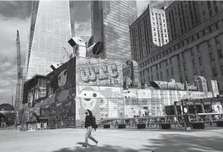  ?? Mark Lennihan / Associated Press ?? Murals surround the foundation for 2 World Trade Center on Wednesday in New York. Developer Larry Silverstei­n says he wants to sign an anchor tenant before starting constructi­on.