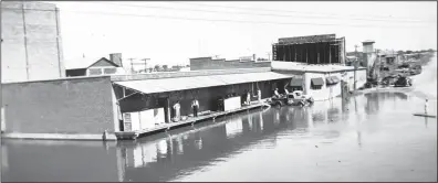  ?? Courtesy photos ?? Pictured above: The Ice House is shown during one of the big floods in 1920. Pictured Below is a delivery ready to go, in the buggy with the driver.