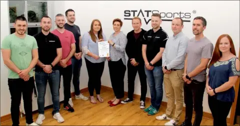  ??  ?? STATSports’ management team receive their ISO accreditat­ion at the company’s Newry headquarte­rs.