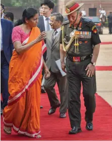  ?? — AP ?? Defence minister Nirmala Sitharaman talks to Army Chief Gen. Bipin Rawat during the ceremonial welcome of South Korean President Moon Jae- in at Rashtrapat­i Bhawan in New Delhi on Tuesday.