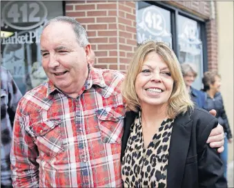  ?? [MIKE SIMONS/ TULSA WORLD] ?? Steve Bear hugs his wife Rhonda Bear after Gov. Kevin Stitt pardoned her at She Brews Coffee House in Claremore on Thursday.