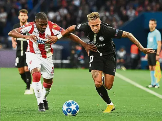  ?? — AFP ?? Going all out: Paris St Germain forward Neymar (right) in action against Red Star Belgrade defender Branko Jovicic during the Champions League Group C match at the Parc des Princes on Wednesday.