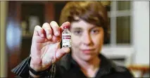  ?? JORGE RIBAS / WASHINGTON POST ?? Laura Marston holds up a vial of Humalog, a type of insulin she takes, at her home in Washington.