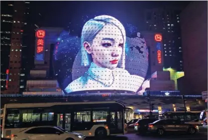  ?? PHOTOS BY CHEN YUYU / FOR CHINA DAILY ?? World’s first glass-free spherical jumbo 3D screen at a shopping center in Shanghai’s downtown Xujiahui area shows the visual effects of the metaverse, in January.