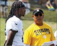  ?? GENE J. PUSKAR — THE ASSOCIATED PRESS ?? Pittsburgh Steelers wide receiver Martavis Bryant, left, listens to receiver coach Hines Ward during practice Sunday. It was Bryant’s first day back with the Steelers following a 13-month drug suspension.