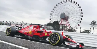  ?? LARS BARON/GETTY IMAGES ?? German driver Sebastian Vettel takes practice laps in his trademark red Scuderia Ferrari SF70H as F1 racing returns to action this weekend at the Japanese Grand Prix.