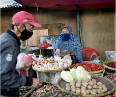  ?? — Reuters ?? A vendor at a traditiona­l market in Jakarta. As the coronaviru­s disease outbreak continues in Asean, it is the most vulnerable who bear the hardest impact.