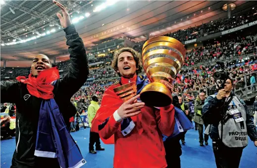  ??  ?? Paris Saint-Germain’s French midfielder Adrien Rabiot holds France’s Ligue 1 trophy after winning the 2014/15 championsh­ip with the club. He is now the highest-profile player among the “lofters” as the club hasn’t fielded him since December. — IC
