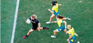  ?? Reuters ?? Kelly Brazier (left) of New Zealand runs to score a try against Australia. —