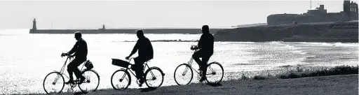  ??  ?? Cyclists pedal along the seafront from Tynemouth to Whitley Bay