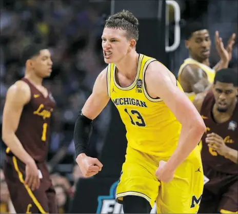  ?? Associated Press ?? Michigan’s Mo Wagner was dominant at both ends of the court with 24 points and 15 rebounds against Loyola-Chicago Saturday in the first national semifinal at Alamodome in San Antonio.