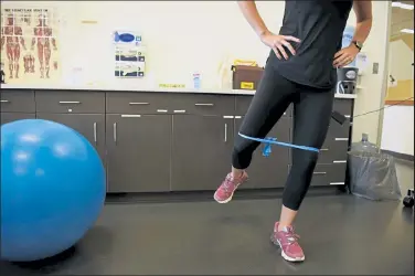  ?? Rachel Ellis / The Denver Post ?? Physical Therapist Chelsea Holt demonstrat­es an exercise called standing fire hydrant with band at The Sports Medicine and Performanc­e Center at The University of Colorado Boulder on Sept. 17. These exercises are designed for people with minimal equipment to train for ski season.